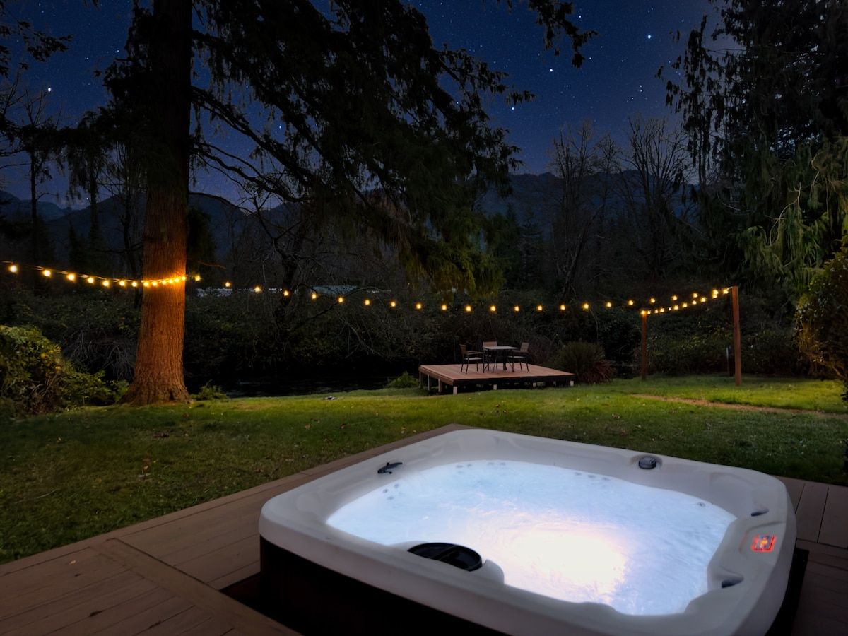 Glowing hot tub under string lights at night
