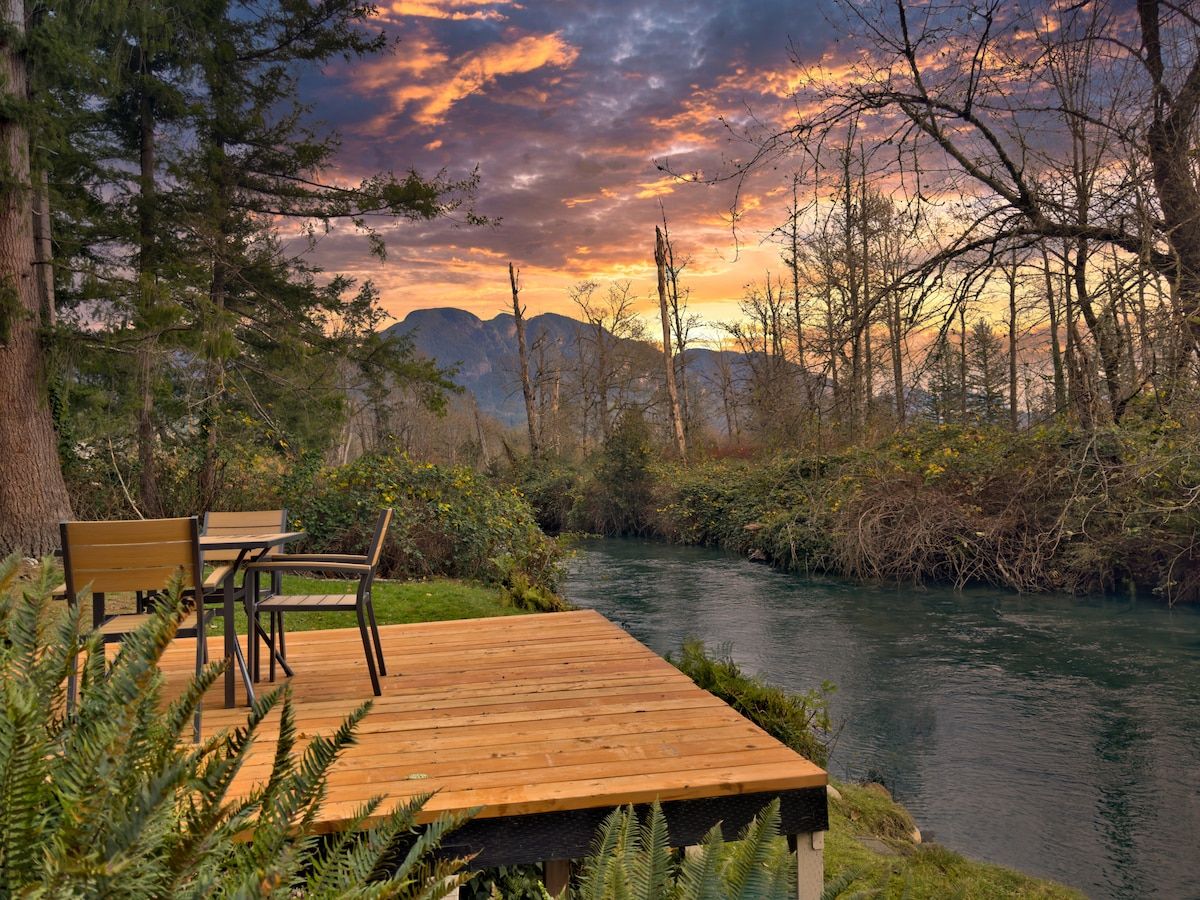 Private deck on May Creek at sunset with the Cascade foothills behind